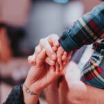 a couple holding hands while holding each other
