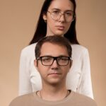 a man and a woman with glasses on their heads